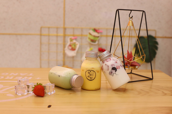 素材と効率の良い飲み物のためのハンドル付きのプラスチック製のミルクティーボトル